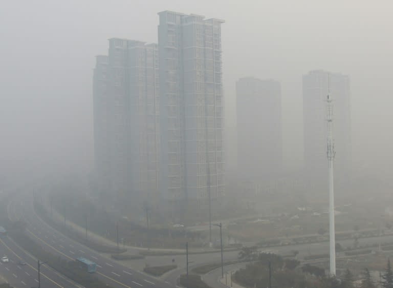 Residential blocks are seen covered in smog in Lianyungang, eastern China's Jiangsu province on November 30, 2015