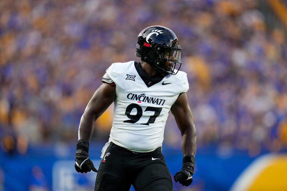 Cincinnati Bearcats defensive end Eric Phillips (97) celebrates a sack in the first quarter of the NCAA football game between the Pittsburgh Panthers and the Cincinnati Bearcats at Acrisure Stadium in Pittsburgh on Saturday, Sept. 9.