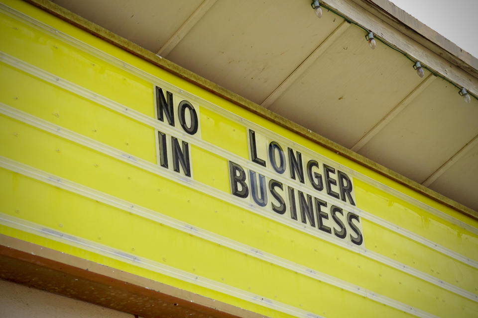 Sign on building reads "NO LONGER IN BUSINESS," indicating a closed establishment