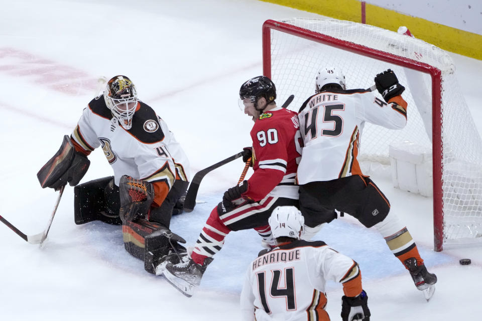 Anaheim Ducks' Colton White (45) keeps Chicago Blackhawks' Tyler Johnson (90) from getting a shot on goal off a pass from Patrick Kane as goaltender Anthony Stolarz also defends during the second period of an NHL hockey game Tuesday, Feb. 7, 2023, in Chicago. (AP Photo/Charles Rex Arbogast)