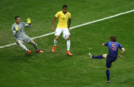 Daley Blind of the Netherlands scores past Brazil's goalkeeper Julio Cesar during their 2014 World Cup third-place playoff at the Brasilia national stadium in Brasilia July 12, 2014. REUTERS/Ruben Sprich