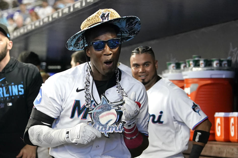 Miami Marlins' Jesus Sanchez celebrates in the dugout after hitting a two-run home run during the first inning of a baseball game against the Philadelphia Phillies, Sunday, July 9, 2023, in Miami. (AP Photo/Lynne Sladky)