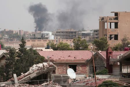 Smoke rises from the northeastern city of Hasaka, Syria, August 21, 2016. REUTERS/Rodi Said