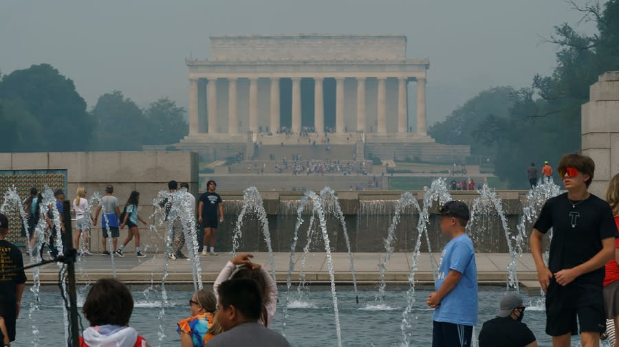 Tourists are seen at the World War II Memorial in Washington, D.C.
