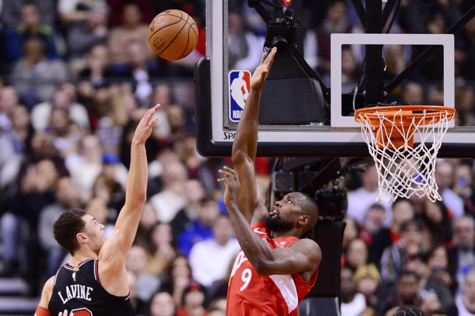 Toronto Raptors forward Serge Ibaka (9) blocks a shot from Chicago Bulls guard Zach LaVine (8) during second-half NBA basketball game action in Toronto, Ontario, Sunday, Dec. 30, 2018. (Frank Gunn/The Canadian Press via AP)