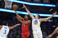 Houston Rockets guard Josh Christopher (9) shoots against Golden State Warriors guard Jordan Poole (3) and forward Nemanja Bjelica (8) during the first half of an NBA basketball game in San Francisco, Friday, Jan. 21, 2022. (AP Photo/Jeff Chiu)