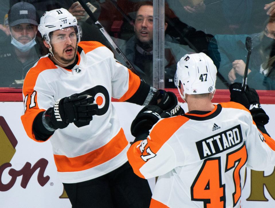 Philadelphia Flyers' Travis Konecny (11) celebrates with Ronnie Attard (47) after scoring against the Montreal Canadiens during the second period of an NHL hockey game Thursday, April 21, 2022, in Montreal. (Graham Hughes/The Canadian Press via AP)