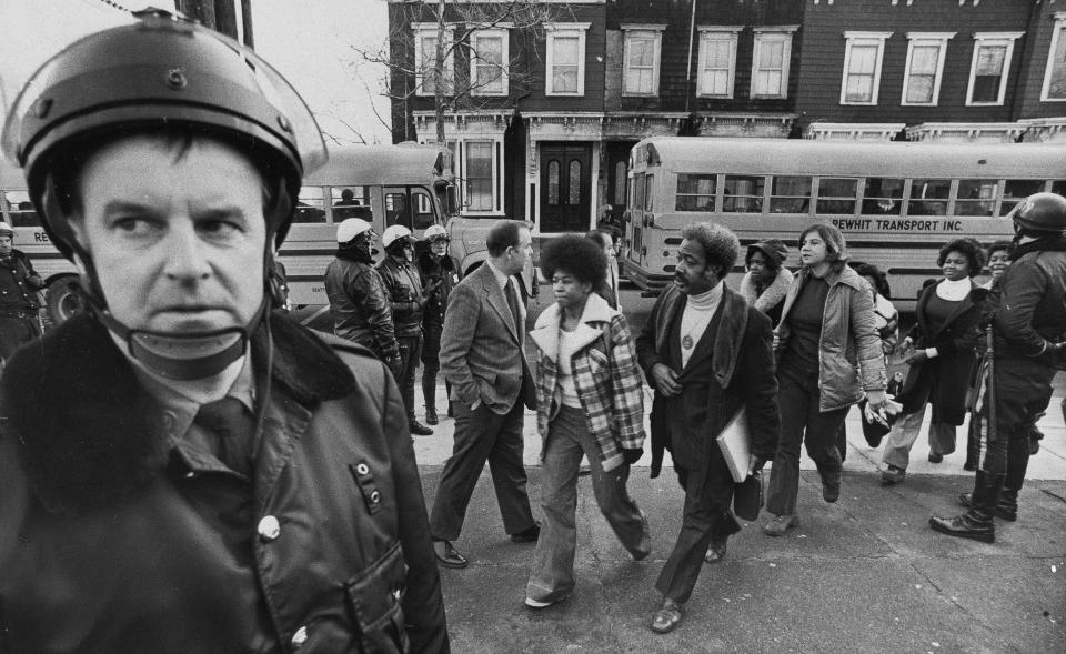 Police were on hand to provide protection as buses carrying Black students arrive at South Boston High School on Jan. 8, 1975. (AP file)