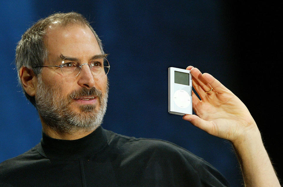 Steve Jobs holding an iPod