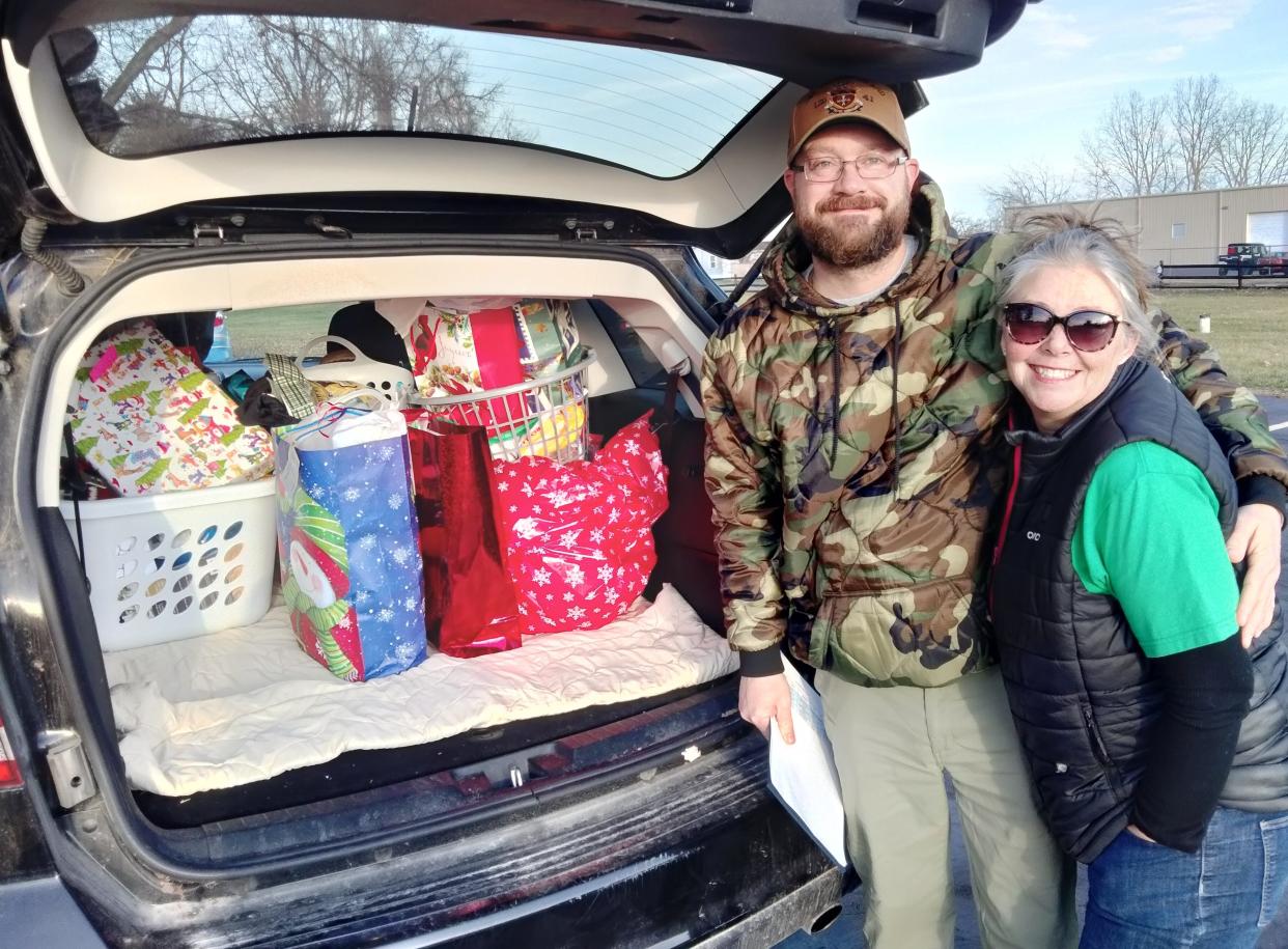 Participating in Operation Christmas Drop, Joel McConnell (Marine), left, and Jamie Paxton (Air Force) and director of Little Blessings Veteran Outreach, prepare to deliver Christmas gifts to disabled and homebound vets.