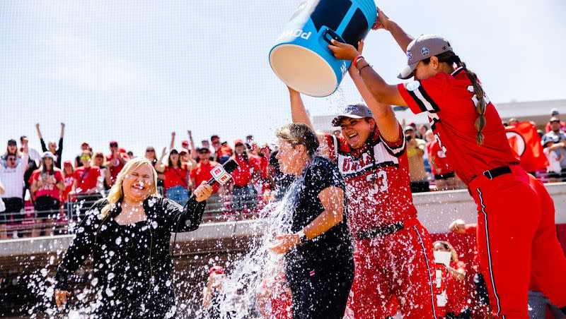 Utah head coach Amy Hogue is soaked with water after winning the NCAA softball Super Regional between Utah and San Diego State at Dumke Family Softball Stadium in Salt Lake City on Sunday, May 28, 2023.