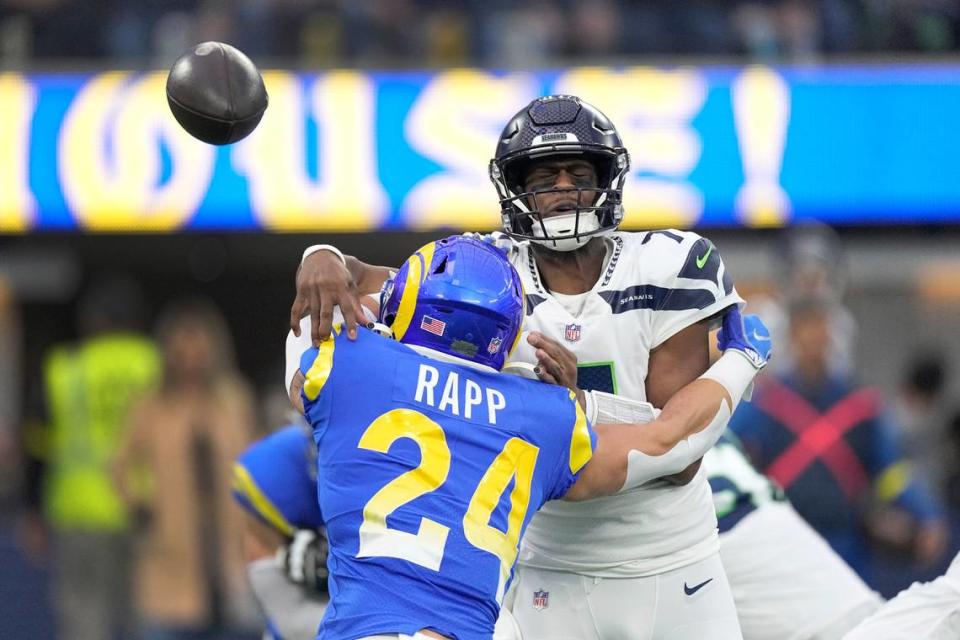 Seattle Seahawks quarterback Geno Smith (7) throws under pressure from Los Angeles Rams safety Taylor Rapp (24) during the first half of an NFL football game Sunday, Dec. 4, 2022, in Inglewood, Calif. (AP Photo/Mark J. Terrill)