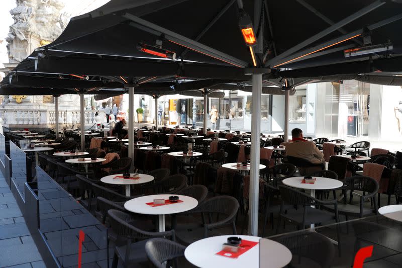 Customers sit in a cafe in Vienna