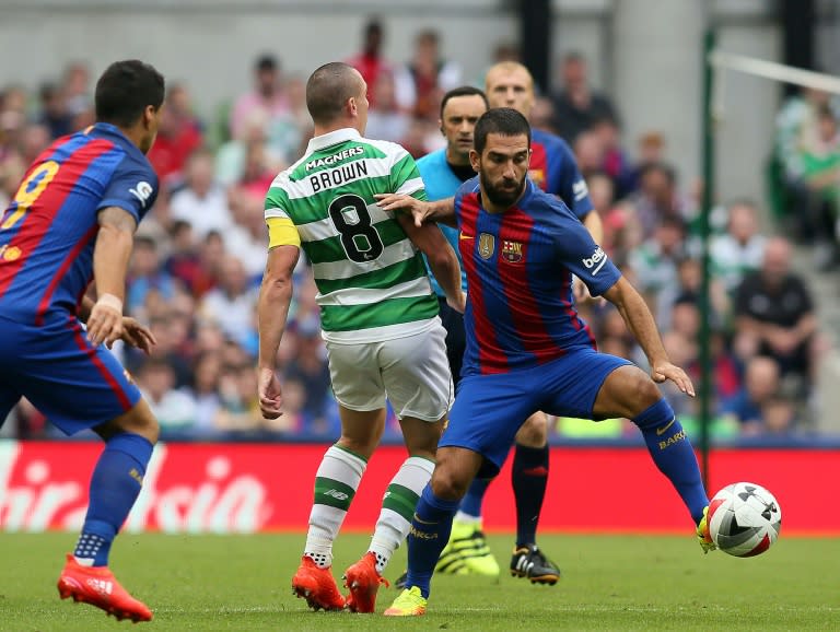 Barcelona's Turkish midfielder Arda Turan (R) passes Celtic's Scott Brown during the pre-season International Champions Cup football match in Dublin on July 30, 2016