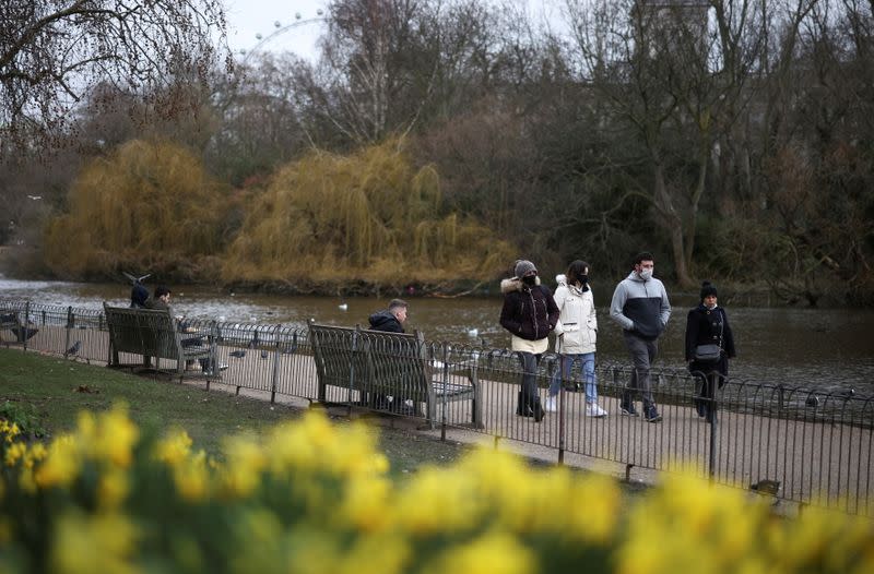 People walk past daffodils in St James's Park, amid the coronavirus disease (COVID-19) outbreak in London