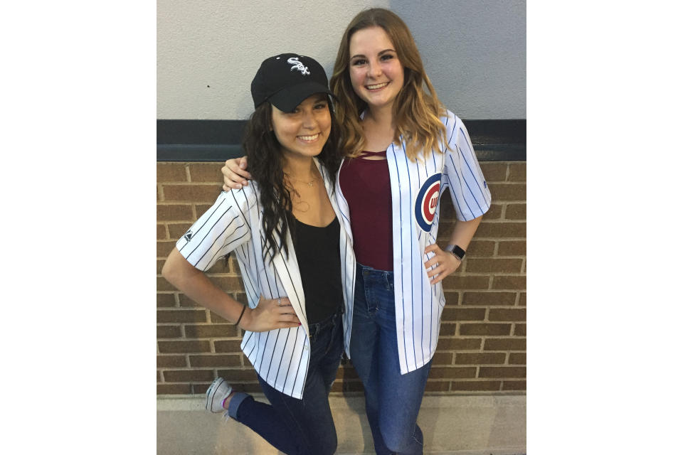 This photo provided by Vince Adamo shows Gabby Adamo, left, and her friend, Emily Heerde celebrating Gabby's 20th birthday by attending a Chicago White Sox-Chicago Cubs baseball game in Chicago, on July 26, 2017. This image was used to make a fan cutout of Gabby Adamo to be displayed at the White Sox Opening Day game. Gabby Adamo rooted for the White Sox throughout a three-year battle with leukemia. But she never got to attend an opening day game featuring her favorite team. (Vince Adamo via AP)