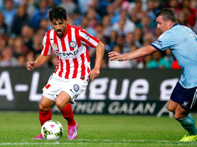 Former Spain striker David Villa (L), playing for Melbourne City football club, prepares to take a shot at goal as Sebastian Ryall from Sydney FC tries to tackle him during their A-League soccer match at the Sydney Football Stadium October 11, 2014. Villa made his A-League debut for Melbourne City this weekend, and is the highest profile recruit to the Australian competition this season. The 32-year old is on loan from New York City, and will play ten games for the Melbourne club, having not played since Spain&#39;s final match of the World Cup against Australia.