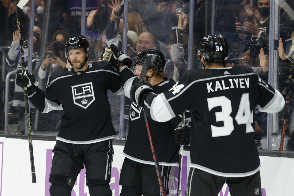 Los Angeles Kings forwards Brendan Lemieux, center, celebrates his goal with Arthur Kaliyev, right, and defenseman Alexander Edler uring the second period of an NHL hockey game against the Arizona Coyotes Sunday, Nov. 21, 2021, in Los Angeles. (AP Photo/Ringo H.W. Chiu)