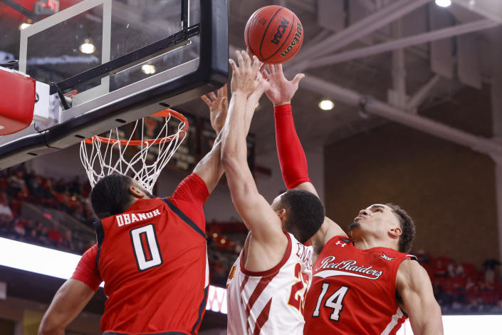 Texas Tech's Marcus Santos-Silva (14) and Kevin Obanor (0) block a shot from Iowa State's Tristan Enaruna (23) during the second half of an NCAA college basketball game on Tuesday, Jan. 18, 2022, in Lubbock, Texas. (AP Photo/Chase Seabolt)