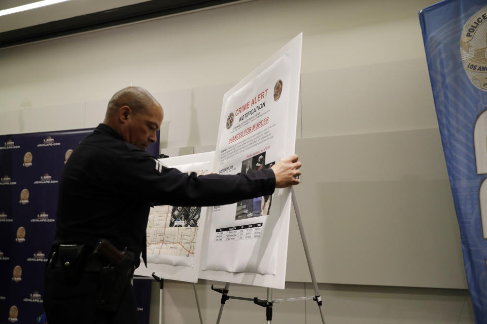 A crime alert bulletin is posted during a press conference at LAPD headquarters Tuesday, Sept. 25, 2018, in Los Angeles. A man arrested on suspicion of beating a Southern California homeless man into unconsciousness and suspected in six other attacks — three of them fatal — also was being investigated in the disappearances of two of the suspect's Texas relatives, officials said Tuesday. (AP Photo/Marcio Jose Sanchez)