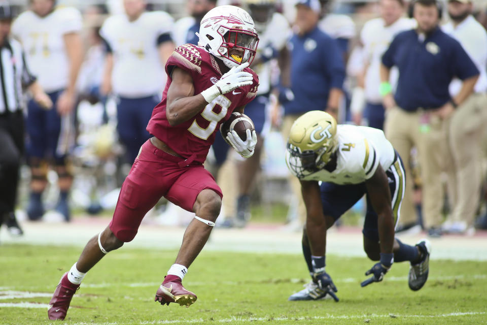 Florida State running back Lawrance Toafili (9) runs for a touchdown past Georgia Tech defensive back Derrik Allen (4) in the second quarter of an NCAA college football game Saturday, Oct. 29, 2022, in Tallahassee, Fla. (AP Photo/Phil Sears)