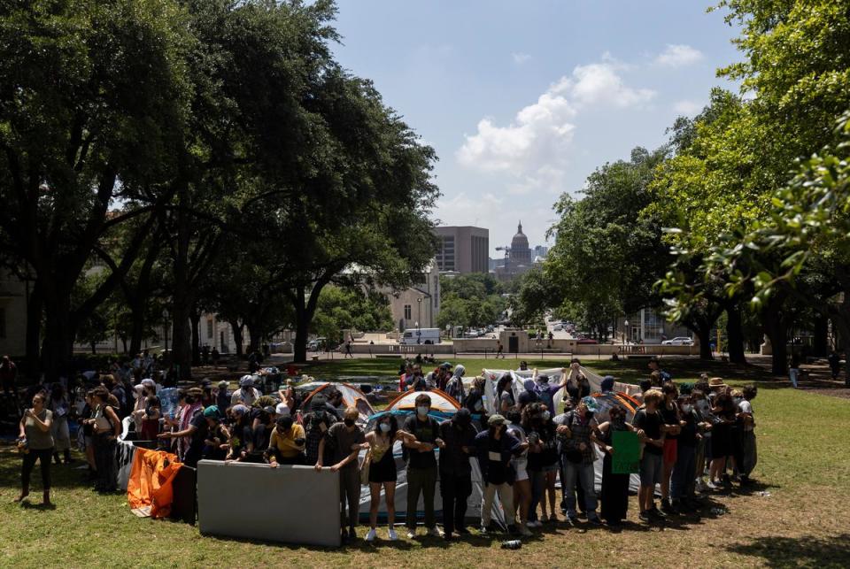 University of Texas at Austin students begin to form an encampment on the South Lawn of the University’s campus on Monday, April 29, 2024. Shortly after, law enforcement, including Texas Department of Public Safety troopers dressed in riot gear, arrived to forcefully remove the pro-Palestinian protesters.