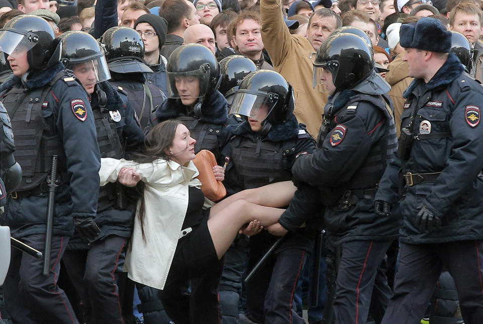 Policemen detain a demonstrator in Moscow