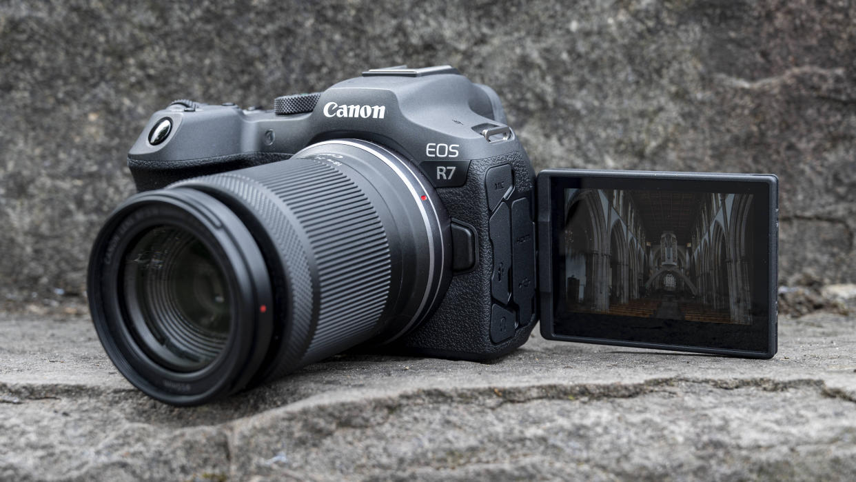  The Canon EOS R7 camera sitting on a stone step. 