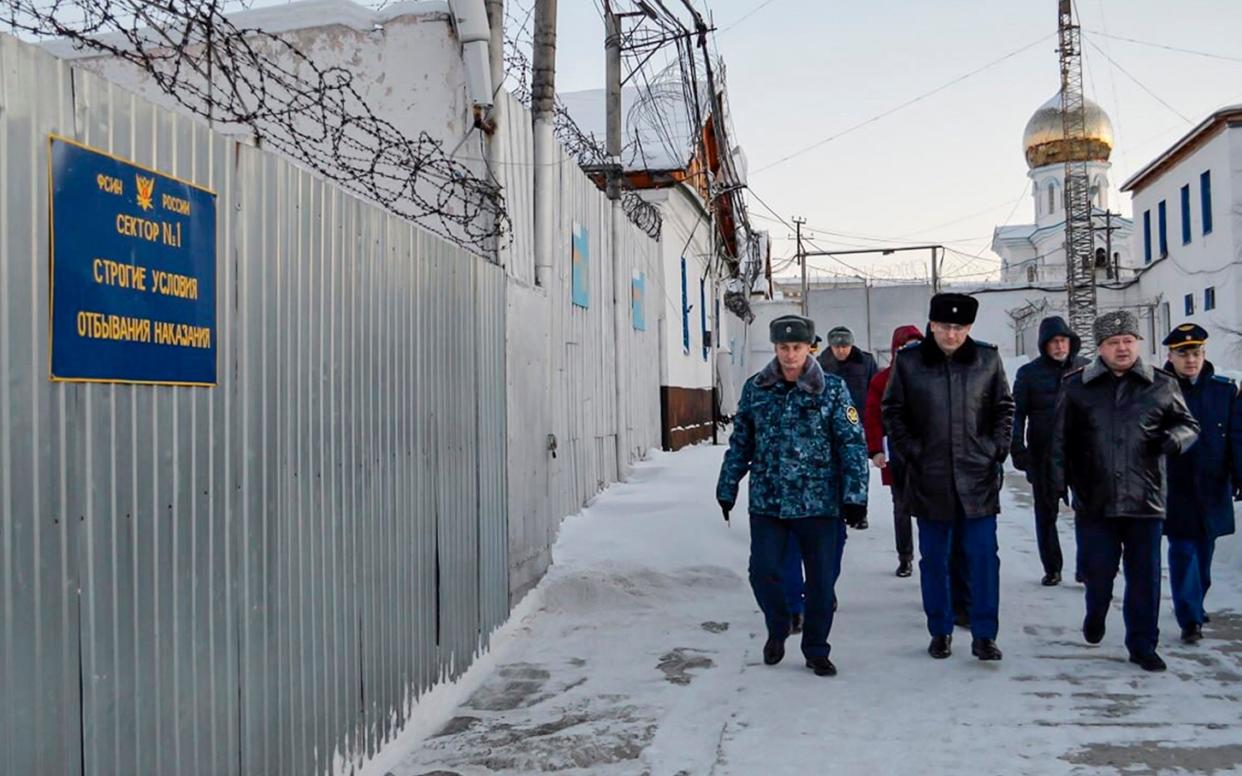 Officers patrol the prison colony in the town of Kharp