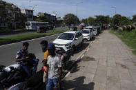 Motorists wait in a queue expecting to buy fuel in Colombo, Sri Lanka, Sunday, June 26, 2022. Sri Lankans have endured months of shortages of food, fuel and other necessities due to the country's dwindling foreign exchange reserves and mounting debt, worsened by the pandemic and other longer term troubles. (AP Photo/Eranga Jayawardena)