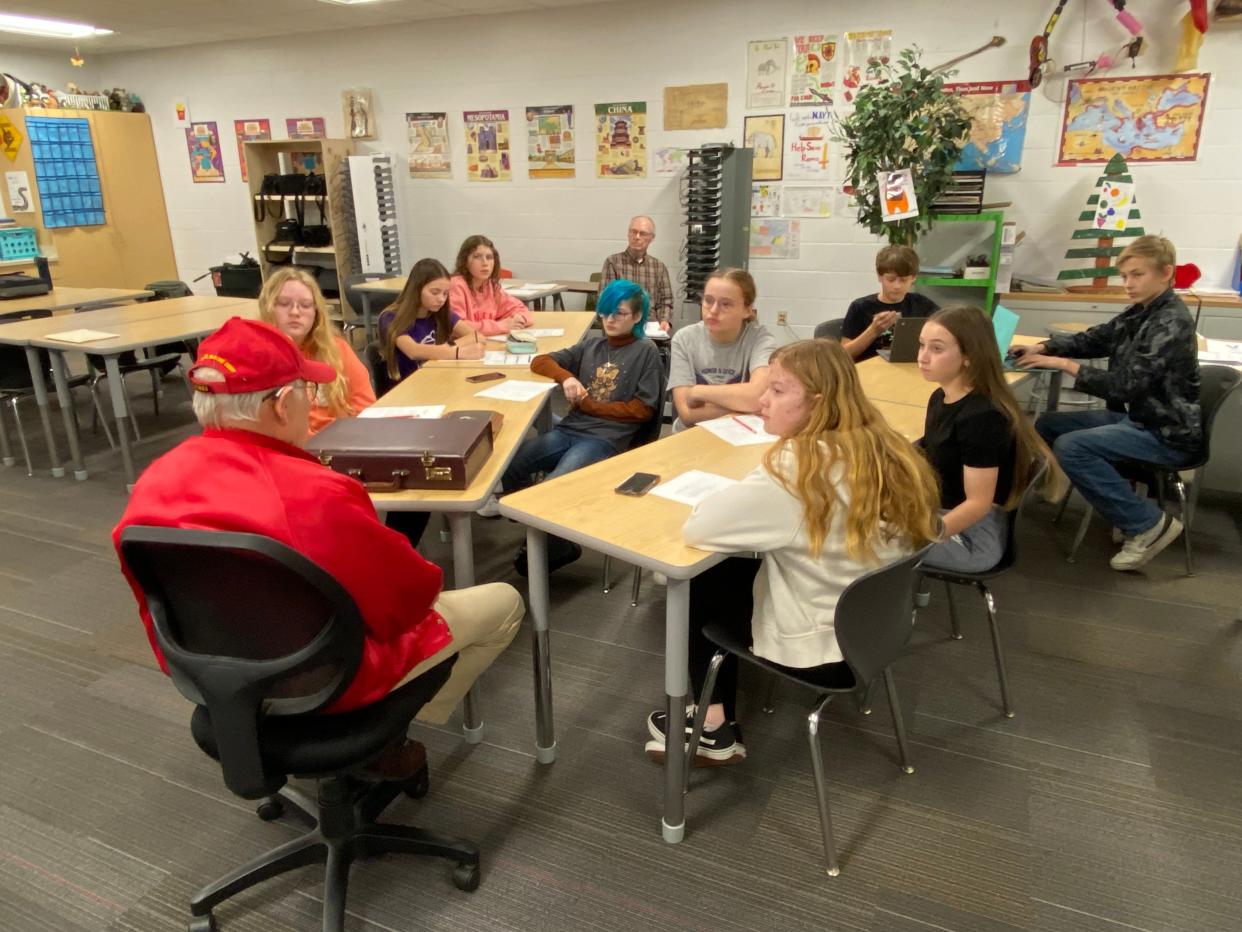 Seventh and eighth graders in East Jordan Middle School's Shoe Club interview a local veteran.