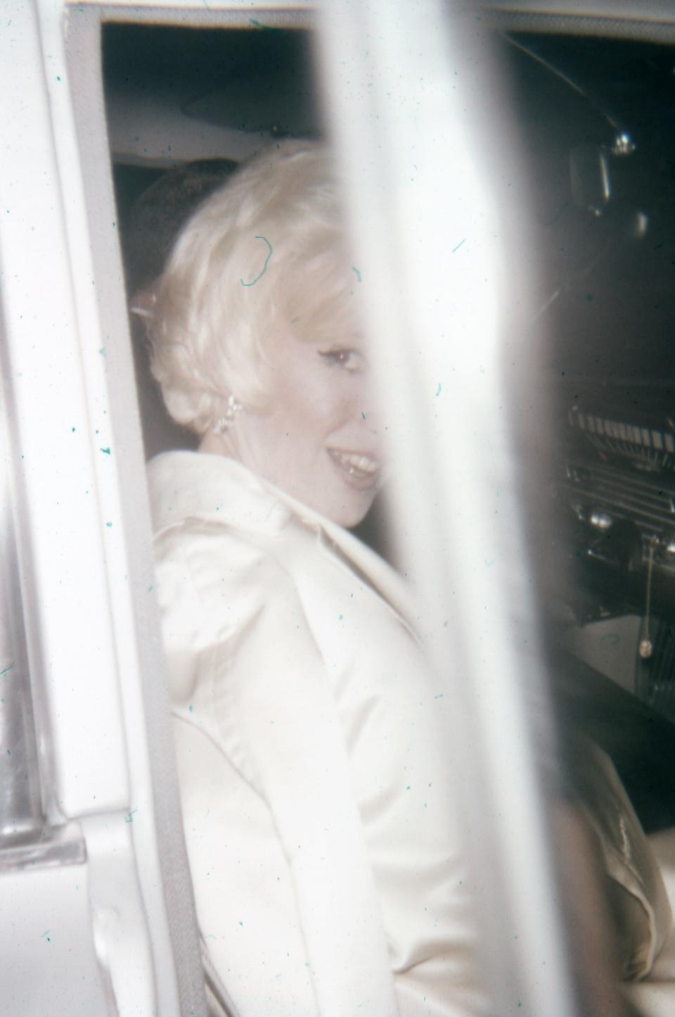 A glimpse of Marilyn Monroe is captured by the photographer as she leaves a dinner party honoring Billy Wilder at the Beverly Hills restaurant Romanoff's.
