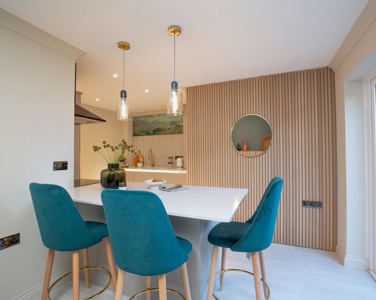  Lighting design in the kitchen with table and blue upholstered chairs. 