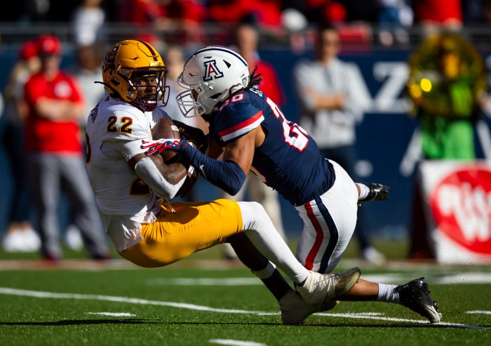 Nov 25, 2022; Tucson, Arizona, USA; Arizona State Sun Devils wide receiver Bryan Thompson (22) is tackled by Arizona Wildcats cornerback Treydan Stukes (20) in the first half of the Territorial Cup at Arizona Stadium.