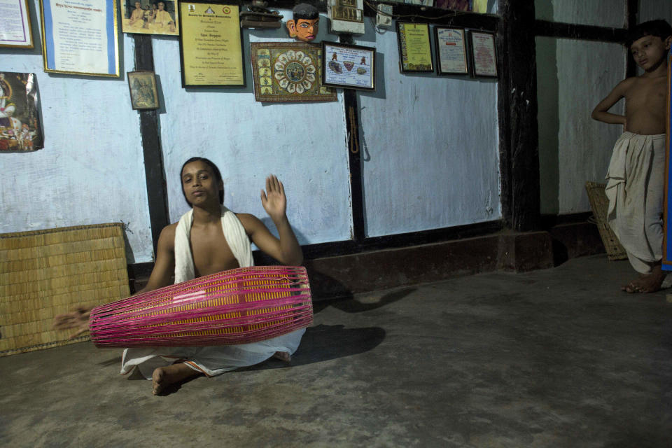 In this Monday, Aug. 6, 2018 photo, a young Hindu monk practices on the Khol, a traditional Assamese instrument, at a Satra, or Vaishnavite monastery, in Majuli, India. Majuli island, one of the world’s largest river islands, is home to more than 20 Vaishnavite monasteries, the traditional praying halls for one of the major offshoots of Hinduism dedicated to the Hindu God Vishnu. Young children and teenagers are being trained in these monasteries to be monks practicing devotional music and art in the Vaishnav tradition. (AP Photo/Anupam Nath)