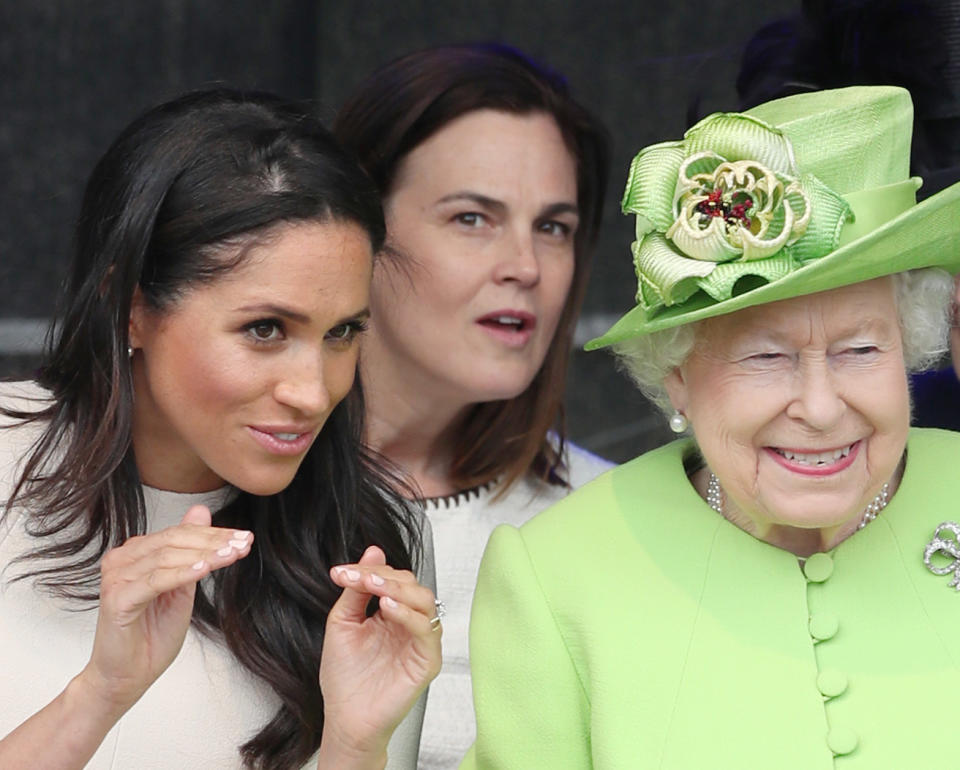 Samantha Cohen can be seen in the background of this photo, taken during Meghan and the Queen’s visit to Cheshire [Photo: PA]