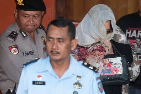 Australian drug convict Schapelle Corby (R) is escorted by police after reporting to a parole office before her expected deportation to Australia, in Denpasar, Bali, Indonesia May 27, 2017 in this photo taken by Antara Foto. Antara Foto/Nyoman Budhiana/via REUTERS