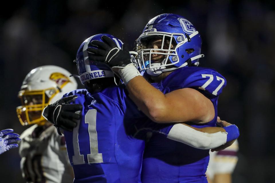 Covington Catholic quarterback Preston Agee (11) celebrates after scoring a touchdown with offensive lineman Peyton Dietz (77) in the second half of the game against Cooper at Covington Catholic High School Sept. 24, 2021.