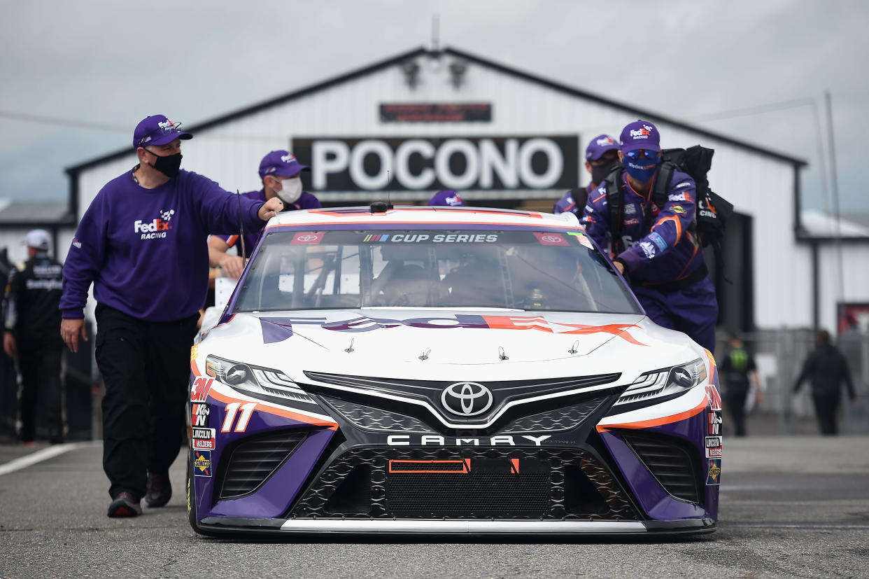 LONG POND, PENNSYLVANIA - JUNE 27: The crew push the #11 FedEx Ground Toyota, driven by Denny Hamlin,  on the grid prior to the NASCAR Cup Series Pocono Organics 325 in partnership with Rodale Institute at Pocono Raceway on June 27, 2020 in Long Pond, Pennsylvania. (Photo by Jared C. Tilton/Getty Images)