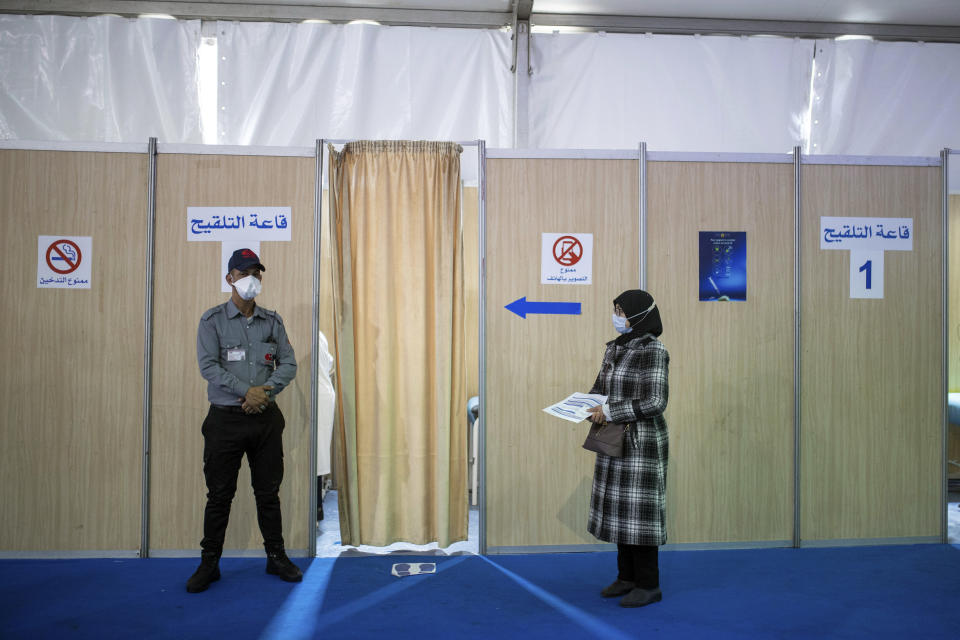 FILE - In this Jan. 29, 2021, file photo, a health workers waits for her turn outside a vaccination booth before receiving the AstraZeneca COVID-19 vaccine, on the first day of the vaccination campaign, in Rabat, Morocco. The suspension of the AstraZeneca vaccine in several European countries could fuel skepticism about the shot far beyond their shores, potentially threatening the rollout of a vaccine that is key to the global strategy to stamp out the coronavirus pandemic, especially in developing nations. (AP Photo/Mosa'ab Elshamy, File)