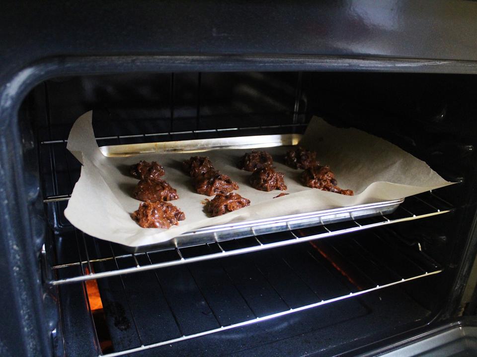 chocolate chip cookie dough on a baking sheet in the oven