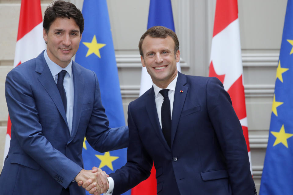 French President Emmanuel Macron, right, and Canadian Prime Minister Justin Trudeau shake hands during a joint press conference at the Elysee Palace in Paris, France, Friday, June 7, 2019. (Philippe Wojazer/Pool via AP)