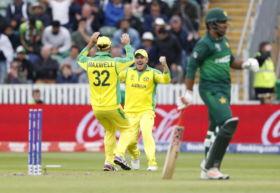 Australia's Glenn Maxwell (32), runs and celebrates with Australia's captain Aaron Finch after running out Pakistan's captain Sarfaraz Ahmed to win the Cricket World Cup match between Australia and Pakistan at the County Ground in Taunton, south west England, Wednesday, June 12, 2019. (AP Photo/Alastair Grant)