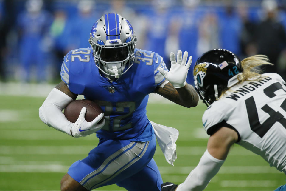 Detroit Lions running back D'Andre Swift rushes past Jacksonville Jaguars safety Andrew Wingard (42) during the second half of an NFL football game, Sunday, Dec. 4, 2022, in Detroit. (AP Photo/Duane Burleson)