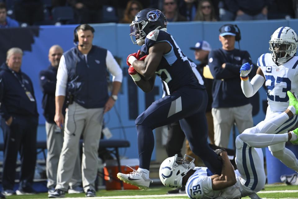 Tennessee Titans' Chigoziem Okonkwo (85) is tackled by Indianapolis Colts' Darrell Baker Jr. (39) during the first half of an NFL football game, Sunday, Dec. 3, 2023, in Nashville, Tenn. (AP Photo/John Amis)