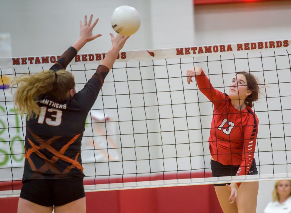 Metamora's Hannah Yoder, right, puts the ball past Washington's Jori Dowling during their Class 3A volleyball regional title game Thursday, Oct. 27, 2022 in Metamora. The Redbirds defeated the Panthers 25-12, 25-19.