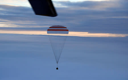 The Soyuz MS-06 capsule carrying the crew of Joe Acaba and Mark Vande Hei of the U.S., and Alexander Misurkin of Russia descends beneath a parachute just before landing in a remote area outside the town of Dzhezkazgan (Zhezkazgan), Kazakhstan, February 28, 2018. REUTERS/Alexander Nemenov/Pool