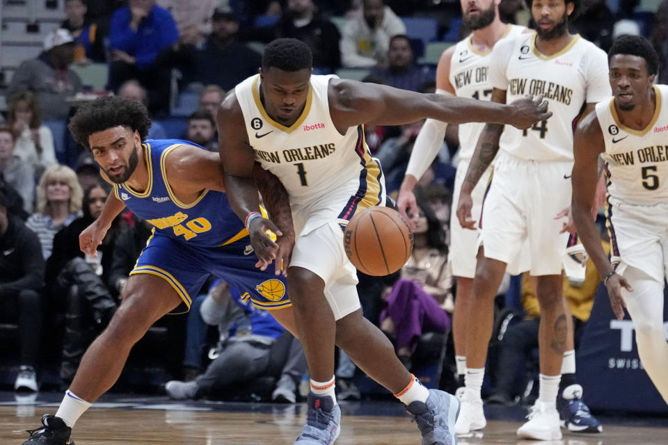 New Orleans Pelicans forward Zion Williamson (1) and Golden State Warriors forward Anthony Lamb (40) chase down a loose ball in the first half of an NBA basketball game in New Orleans, Monday, Nov. 21, 2022. (AP Photo/Gerald Herbert)