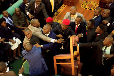 Ugandan lawmakers involve in a fight in the parliament ahead of proposed age limit amendment bill debate a move to change the constitution to extend the president's rule, in Kampala, Uganda September 26, 2017. REUTERS/James Akena