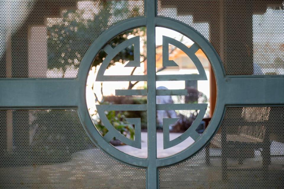 A gate at the Ping Yuen Apartments building features a stylized Chinese design.